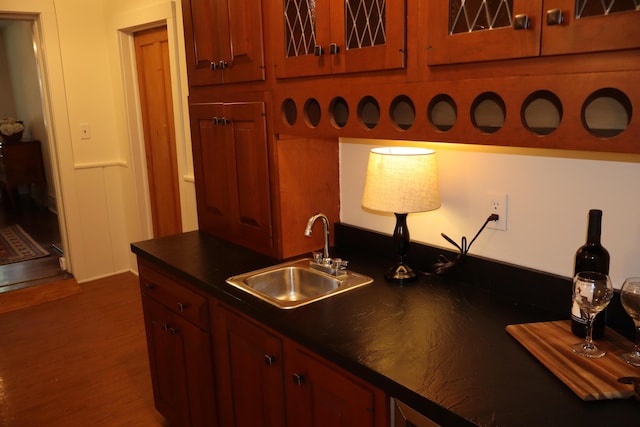 408 N Church St, Fayette, MO 65248 - kitchen featuring dark countertops, wood finished floors, and glass insert cabinets