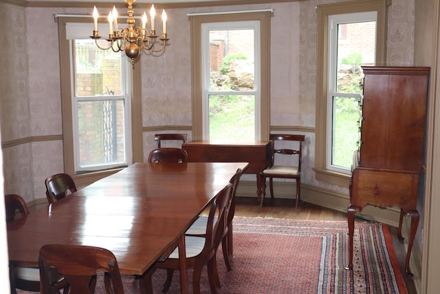 408 N Church St, Fayette, MO 65248 - dining space featuring wallpapered walls, a chandelier, and wood finished floors