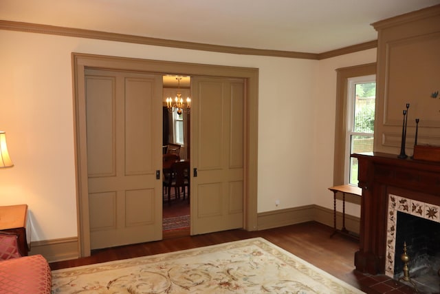 408 N Church St, Fayette, MO 65248 - living area with wood finished floors, a chandelier, ornamental molding, and a fireplace