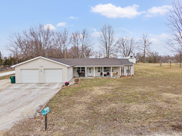 view of front facade with a garage, driveway, a porch, and a front lawn