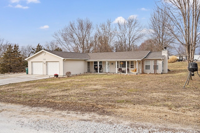 ranch-style house featuring a porch, concrete driveway, a chimney, and a garage