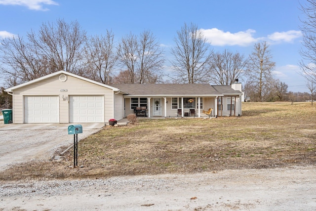 single story home featuring a garage, dirt driveway, a chimney, and a porch