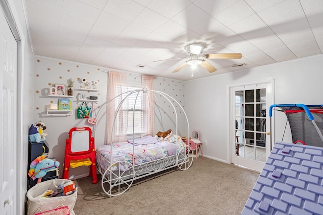 bedroom featuring a ceiling fan, carpet, visible vents, and ornamental molding