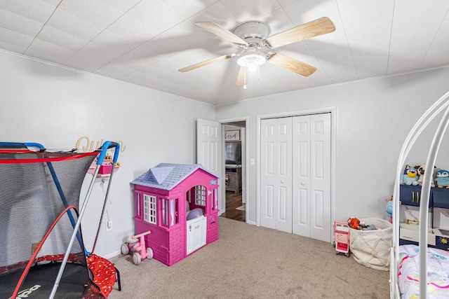 game room with carpet floors and ceiling fan