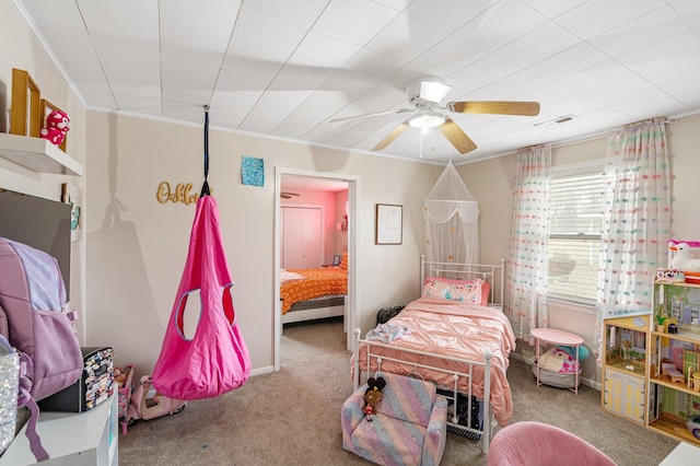 bedroom with a ceiling fan, carpet, visible vents, and crown molding