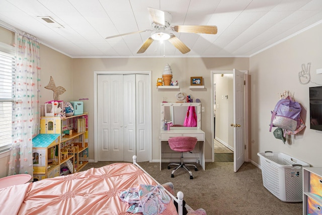 bedroom featuring carpet floors, a ceiling fan, baseboards, a closet, and crown molding