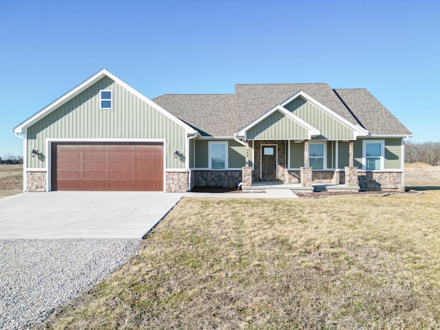 craftsman inspired home featuring driveway, a front lawn, stone siding, an attached garage, and a shingled roof