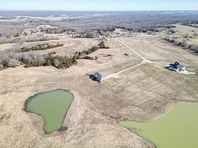 drone / aerial view featuring a water view and a rural view