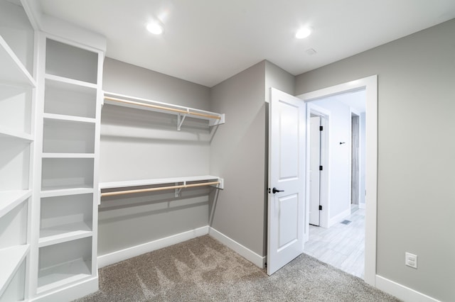 spacious closet with carpet flooring