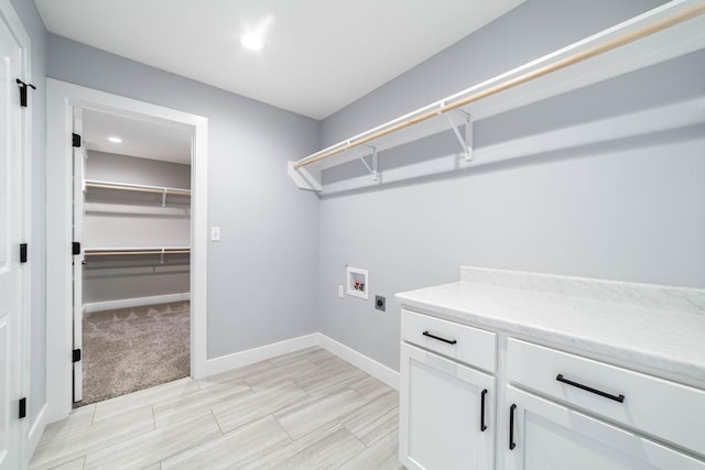 washroom with electric dryer hookup, recessed lighting, cabinet space, baseboards, and hookup for a washing machine