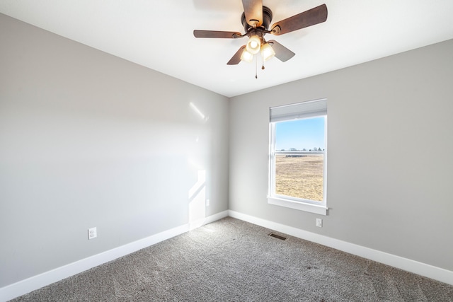 carpeted empty room with a ceiling fan, baseboards, and visible vents