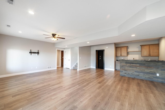 unfurnished living room with visible vents, baseboards, recessed lighting, light wood-style flooring, and a ceiling fan