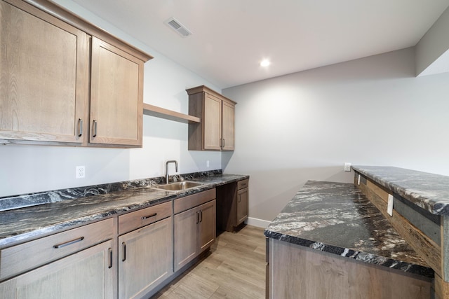 kitchen featuring visible vents, baseboards, recessed lighting, light wood-style floors, and a sink