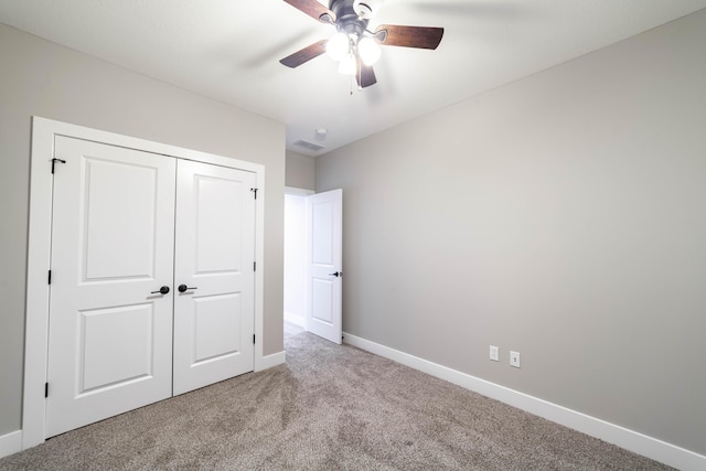 unfurnished bedroom with visible vents, a ceiling fan, a closet, carpet, and baseboards