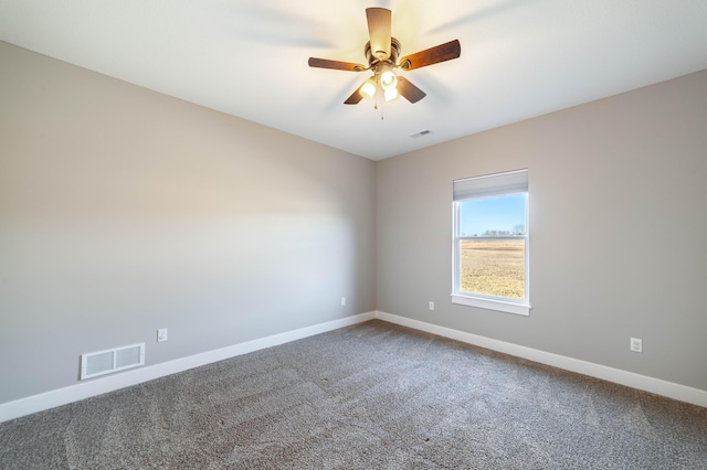 spare room featuring visible vents, baseboards, and carpet