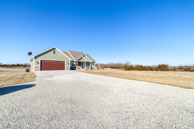 view of front of property with concrete driveway, a garage, and stone siding