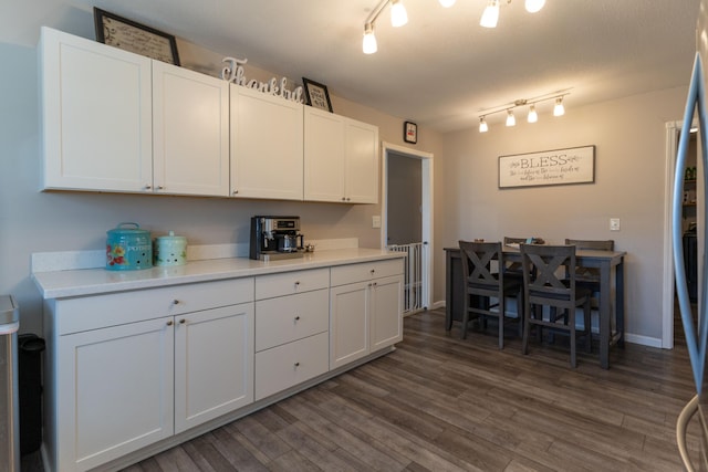 kitchen featuring dark wood finished floors, track lighting, white cabinets, and light countertops