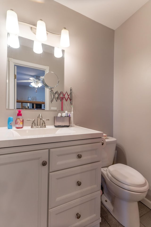 bathroom featuring toilet, vanity, and tile patterned flooring