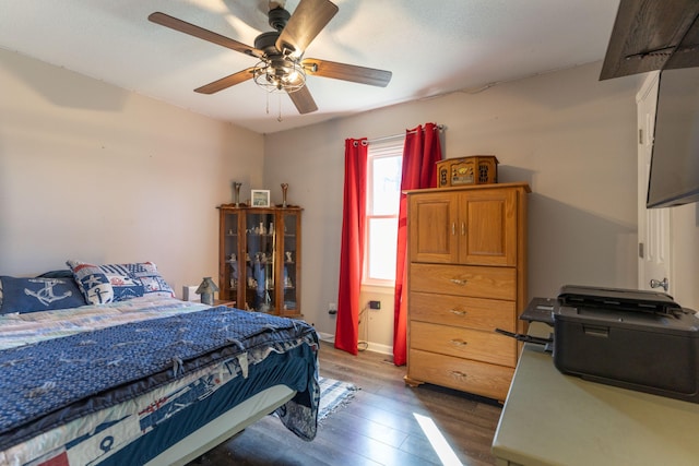 bedroom with ceiling fan and dark wood-style flooring