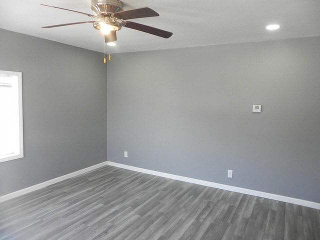 unfurnished room featuring a ceiling fan, baseboards, and wood finished floors