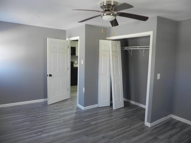 unfurnished bedroom with a closet, baseboards, and wood finished floors