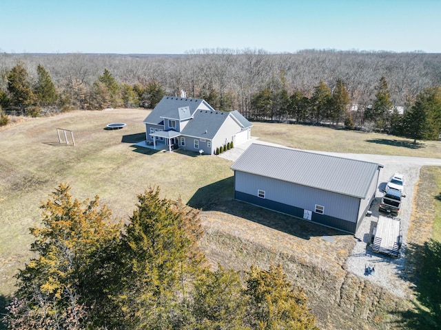 birds eye view of property featuring a wooded view