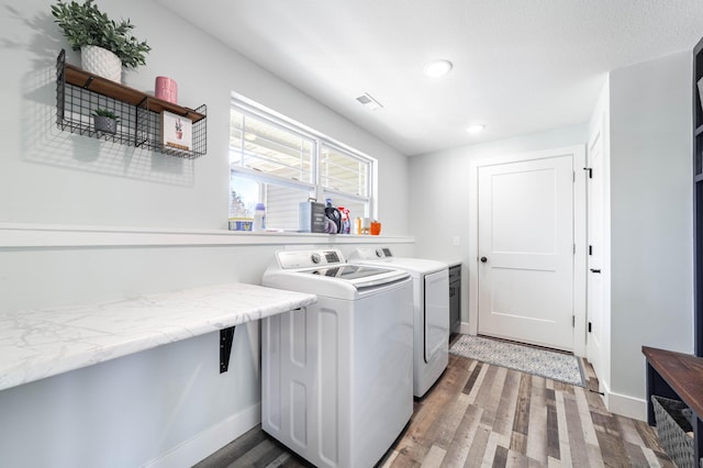 clothes washing area featuring laundry area, light wood-style flooring, baseboards, and independent washer and dryer