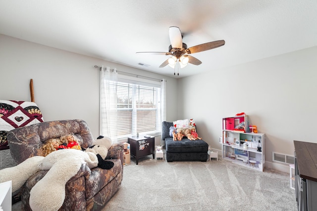 interior space with visible vents, ceiling fan, light carpet, and baseboards