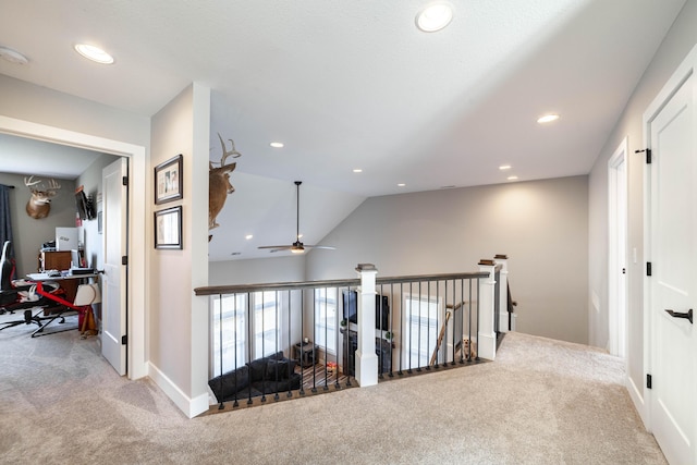 hallway featuring vaulted ceiling, carpet, an upstairs landing, and recessed lighting