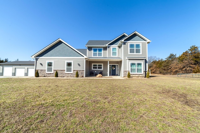 craftsman inspired home featuring a garage, stone siding, a front lawn, and a porch