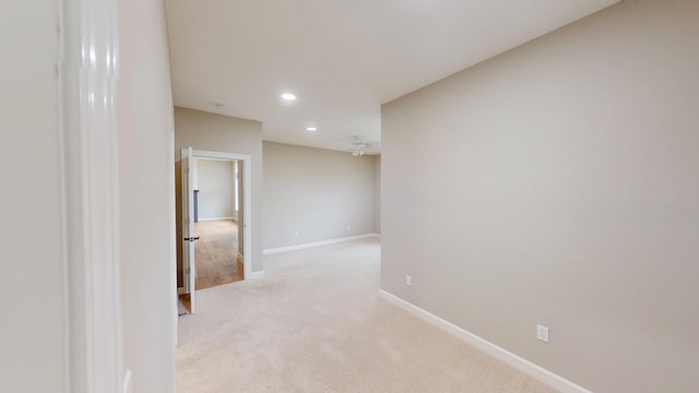 empty room with recessed lighting, baseboards, and light colored carpet