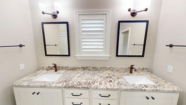 full bathroom featuring a sink and double vanity