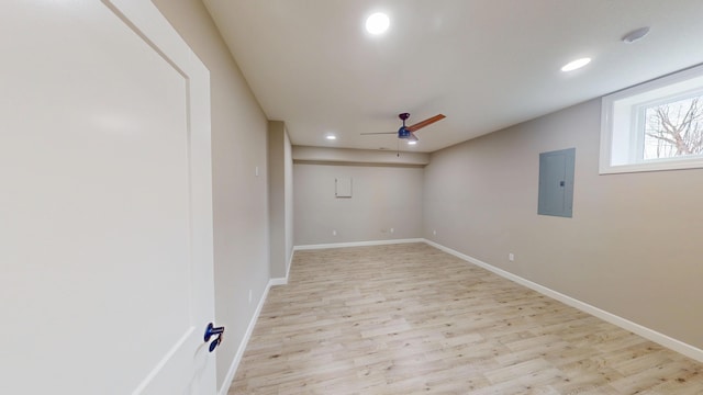 spare room featuring recessed lighting, a ceiling fan, baseboards, electric panel, and light wood finished floors