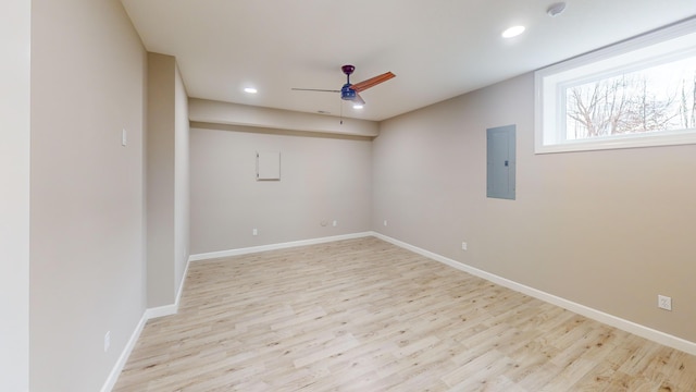 spare room with recessed lighting, a ceiling fan, baseboards, electric panel, and light wood finished floors