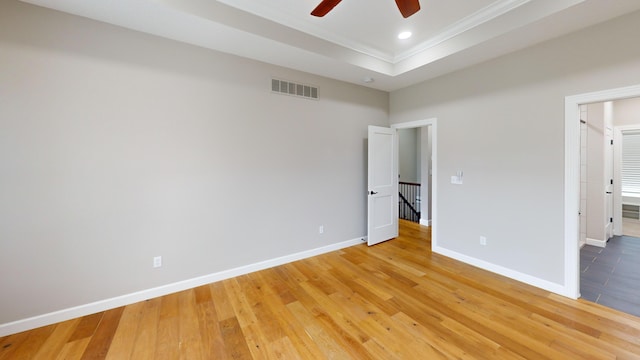 unfurnished bedroom featuring visible vents, light wood finished floors, and baseboards