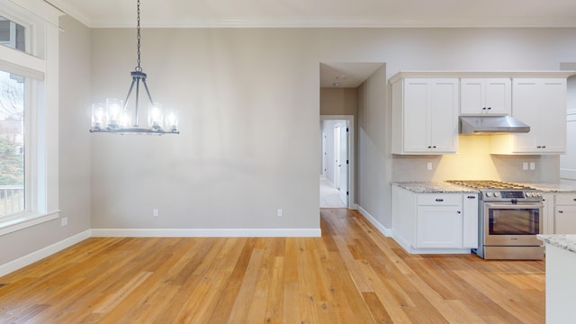 kitchen featuring light wood-type flooring, under cabinet range hood, stainless steel range with gas cooktop, and white cabinets