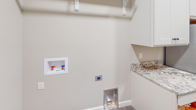 clothes washing area with cabinet space, hookup for a washing machine, baseboards, and hookup for an electric dryer