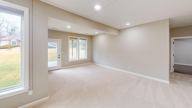 empty room featuring light carpet, baseboards, and recessed lighting