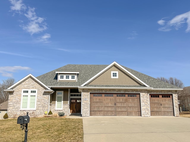 view of front of house featuring a garage, a front yard, concrete driveway, and roof with shingles