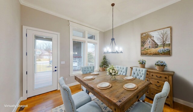 dining area with a chandelier, baseboards, crown molding, and light wood finished floors