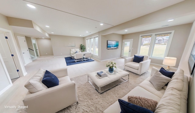 living area with recessed lighting, light colored carpet, and baseboards