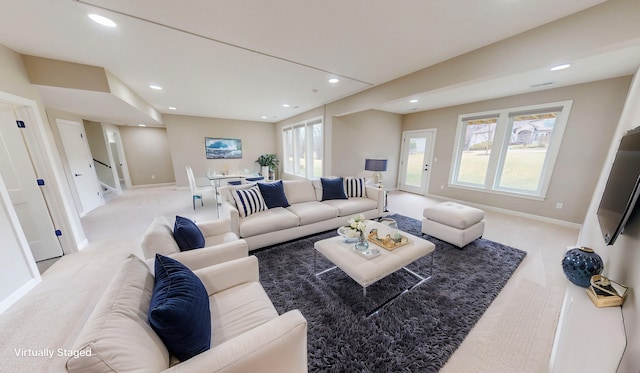 living room featuring recessed lighting, baseboards, and stairs