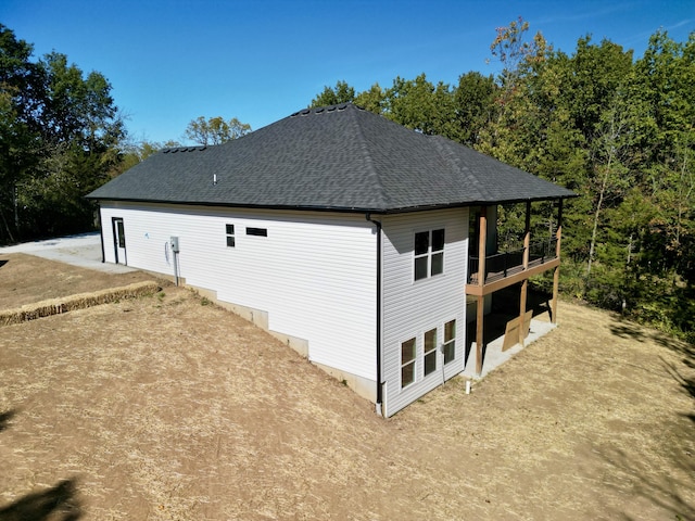 view of home's exterior featuring roof with shingles