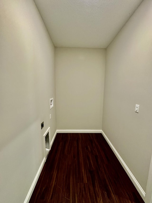 laundry room with hookup for a washing machine, laundry area, wood finished floors, baseboards, and electric dryer hookup