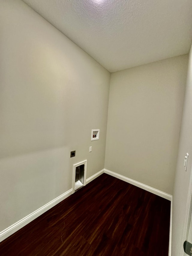 laundry area with washer hookup, dark wood finished floors, electric dryer hookup, laundry area, and baseboards