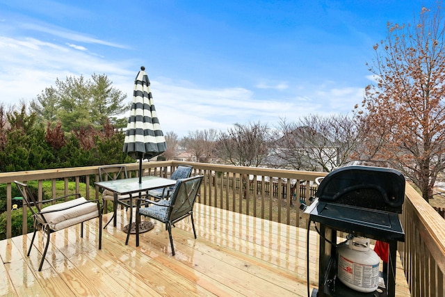 wooden terrace featuring outdoor dining area and a grill