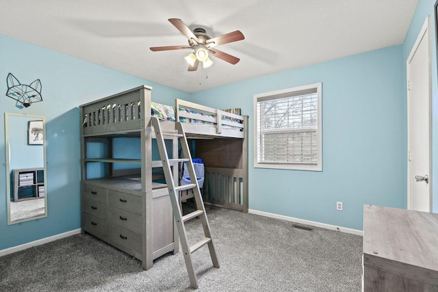 carpeted bedroom featuring ceiling fan, visible vents, and baseboards