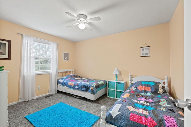 carpeted bedroom featuring visible vents, ceiling fan, and baseboards