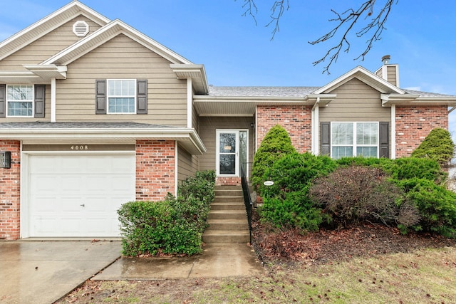 view of front of house featuring a garage, brick siding, driveway, and roof with shingles