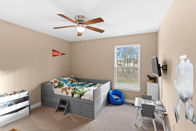 carpeted bedroom featuring baseboards and ceiling fan